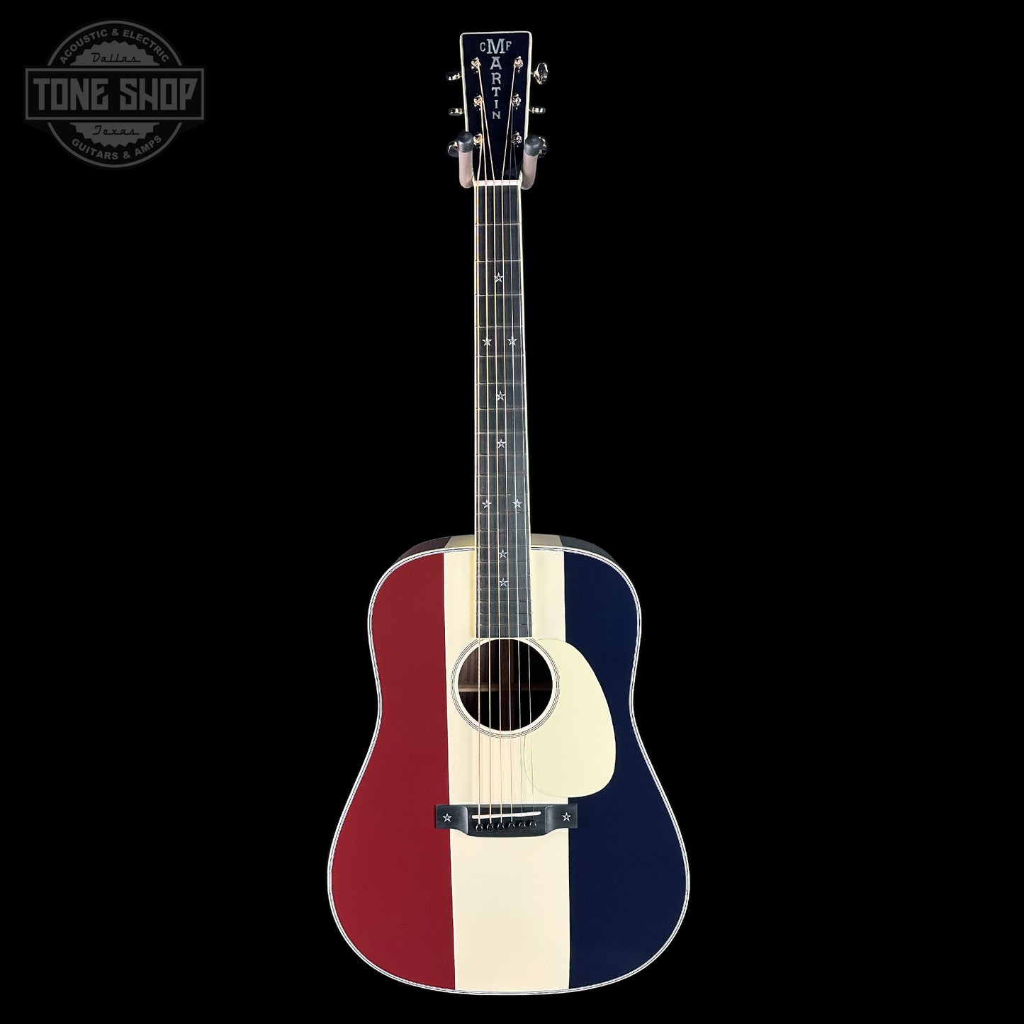 Acoustic guitar with a red, white, and blue design on a black background
