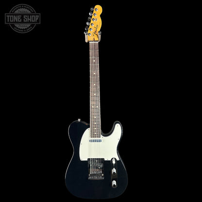 Electric guitar with a black body and white pickguard on a black background, featuring the Tone Shop logo.