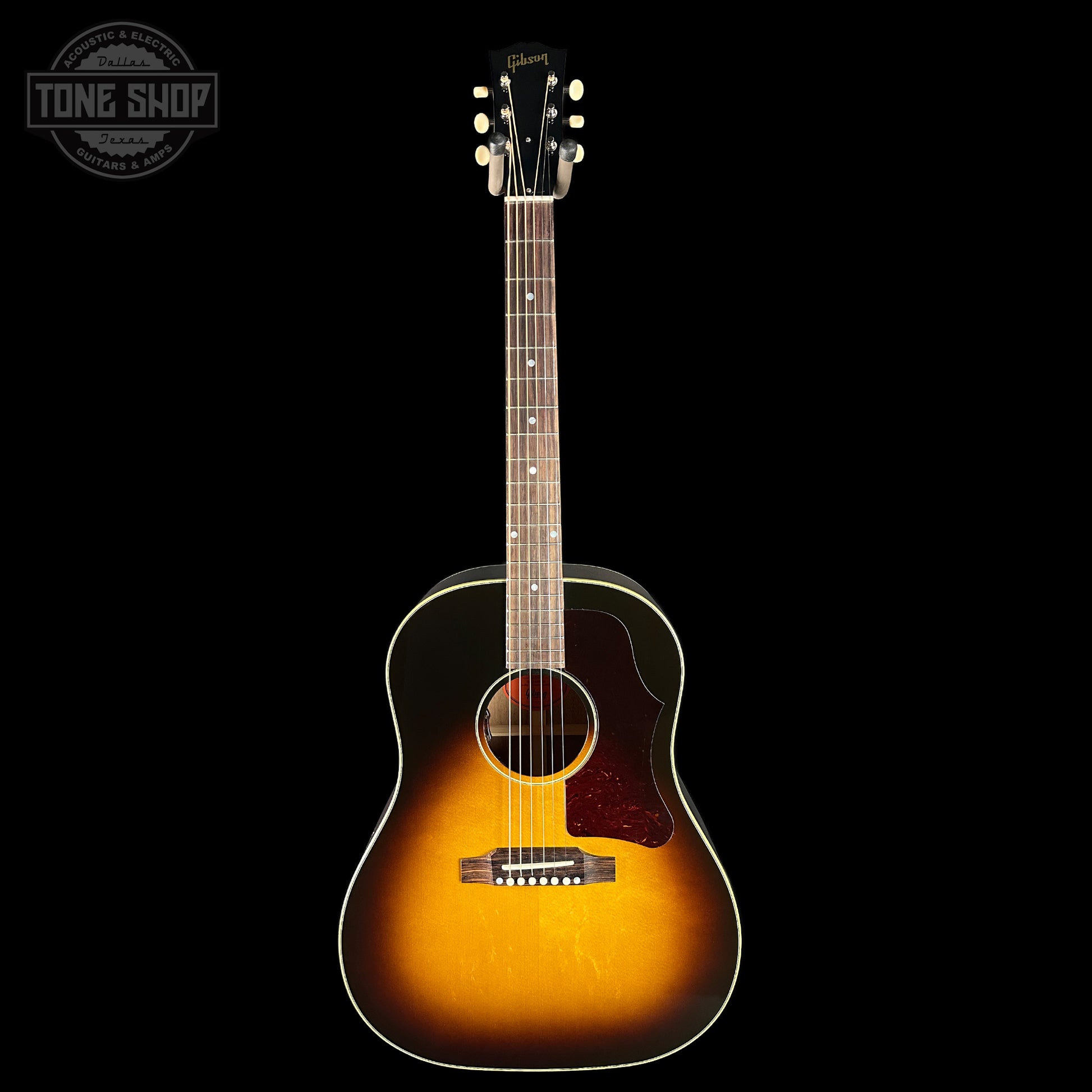 Acoustic guitar with a sunburst finish on a black background, featuring the Tone Shop logo.