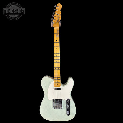 Electric guitar with a light finish on a black background, featuring the Tone Shop logo.