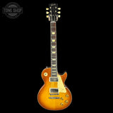 Electric guitar with a sunburst finish on a black background, featuring the Gibson logo.