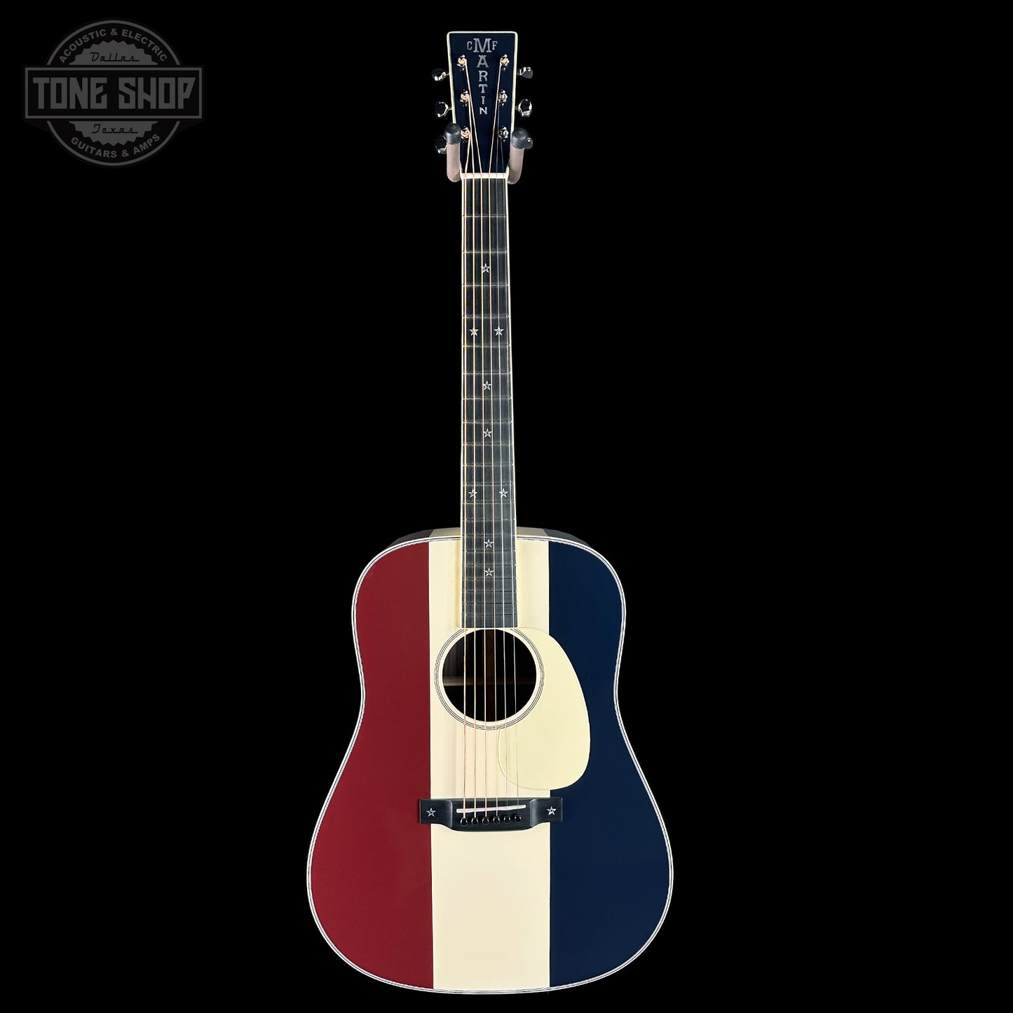 Acoustic guitar with a red, white, and blue design on a black background