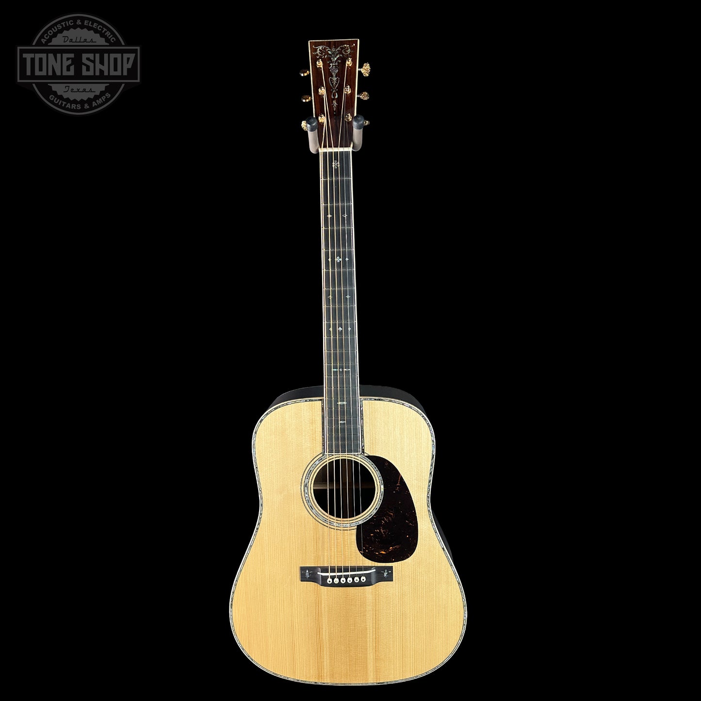 Acoustic guitar on a black background with 'Tone Shop' logo.