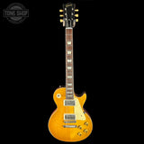 Electric guitar with a sunburst finish on a black background, featuring the Gibson logo.