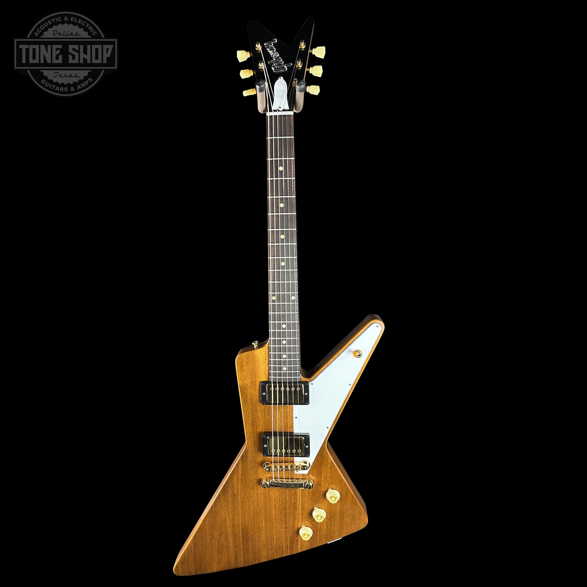 Wooden electric guitar with a white pickguard on a black background, featuring the Tone Shop logo.