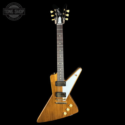 Wooden electric guitar with a white pickguard on a black background, featuring the Tone Shop logo.