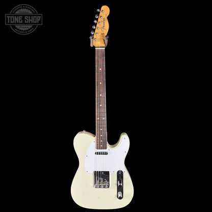 White electric guitar with a black background, featuring the Tone Shop logo.