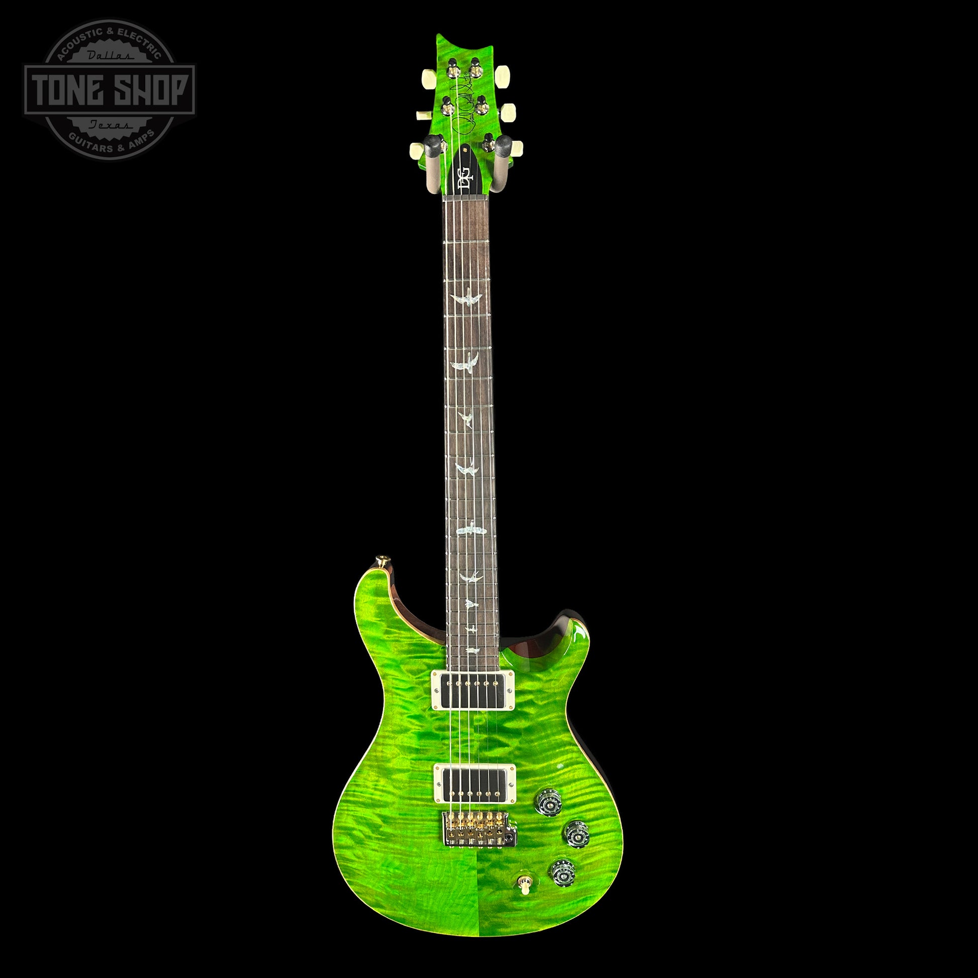 Green electric guitar on a black background with 'Tone Shop' logo.