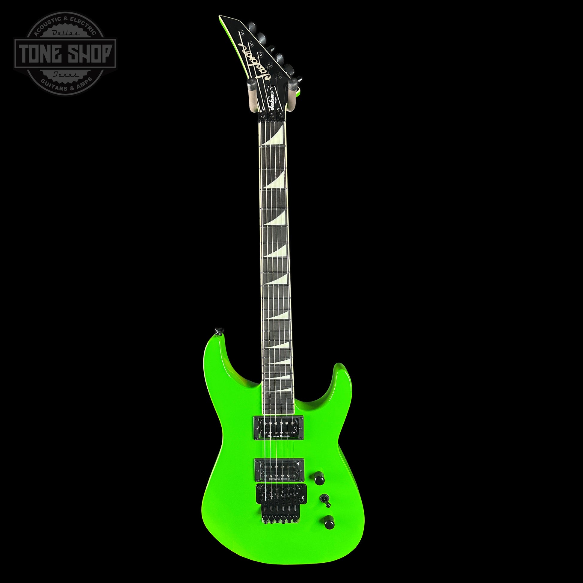 Green electric guitar on a black background with 'Tone Shop' logo.