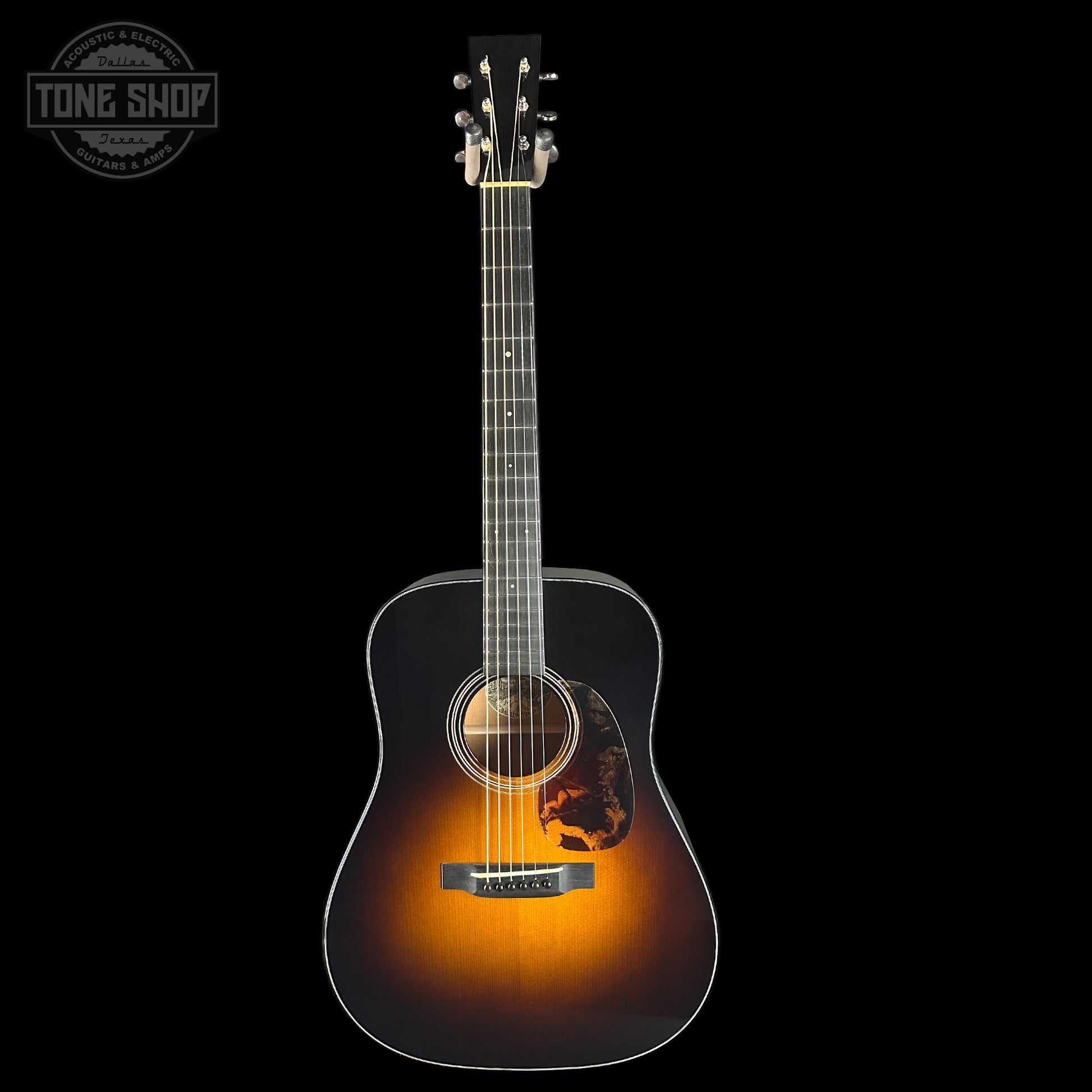 Acoustic guitar with a sunburst finish on a black background, featuring the Tone Shop logo.
