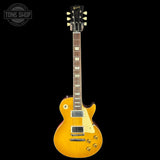 Gibson Les Paul electric guitar with a sunburst finish on a black background, featuring the Tone Shop logo.