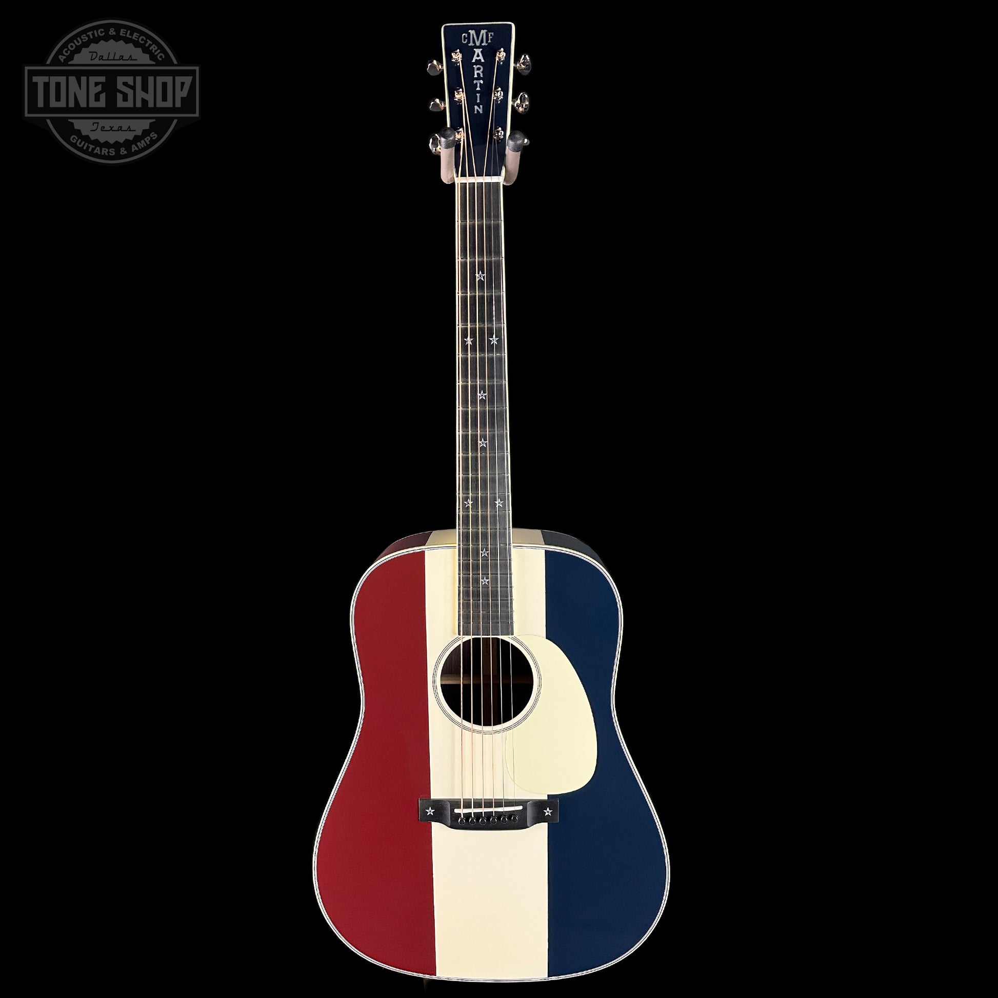 Acoustic guitar with a red, white, and blue design on a black background
