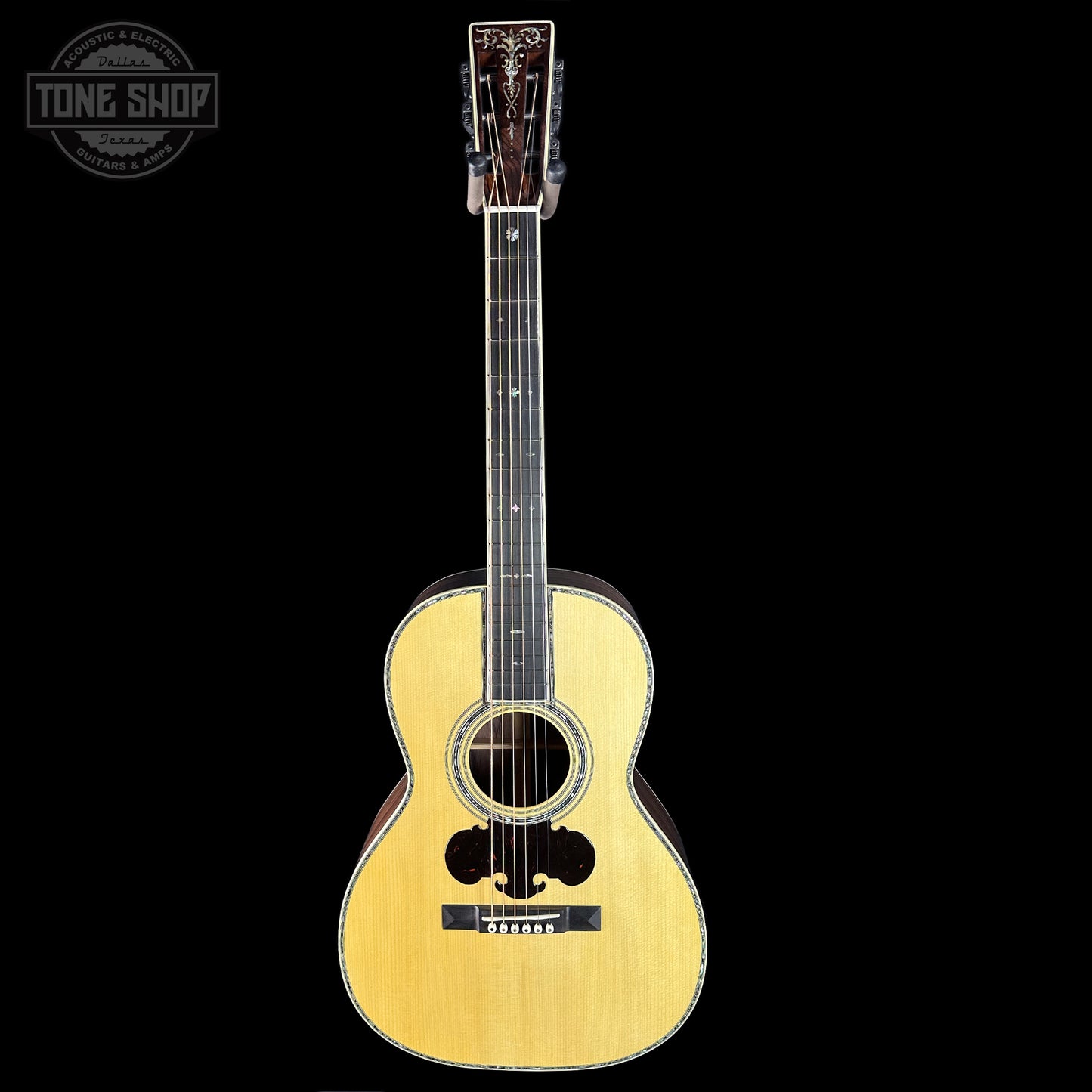 Acoustic guitar with a 'Tone Shop' logo in the corner