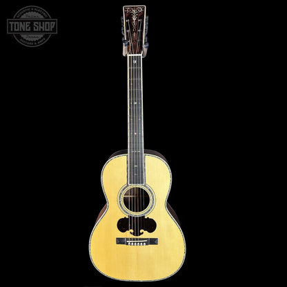 Acoustic guitar with a 'Tone Shop' logo in the corner