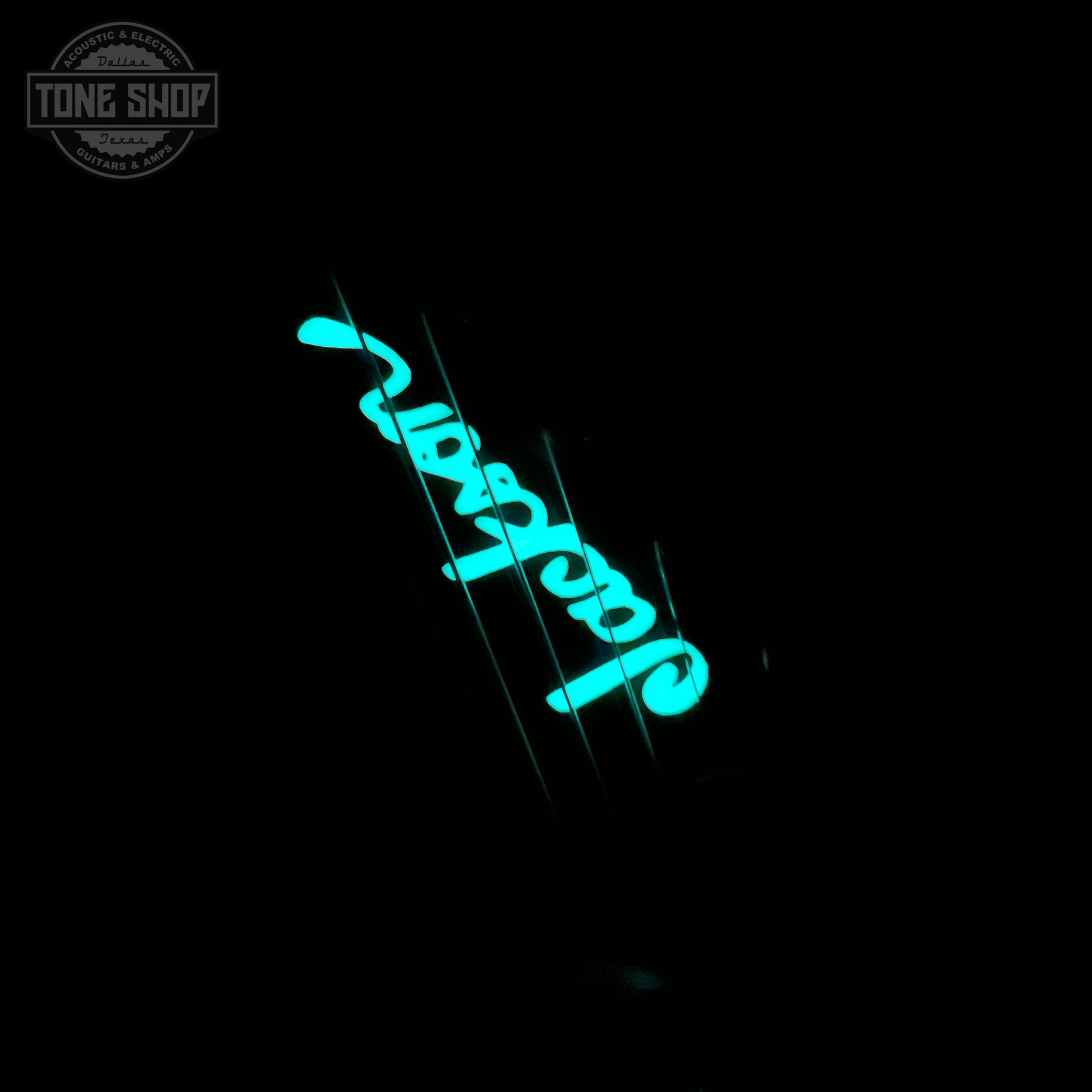 Glowing inlay on headstock of Jackson Custom Shop TSG Illuminati SL2H FR Vanilla Shake.