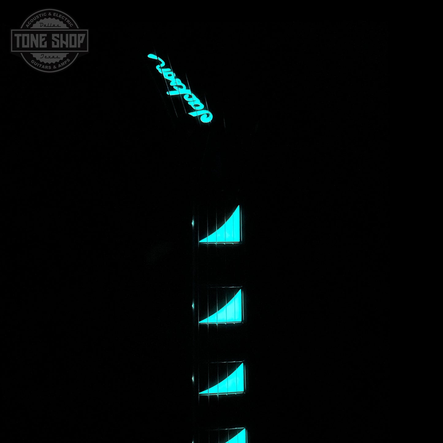 Guitar with blue glowing inlays on a black background, featuring the Tone Shop logo.