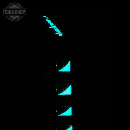 Guitar with blue glowing inlays on a black background, featuring the Tone Shop logo.