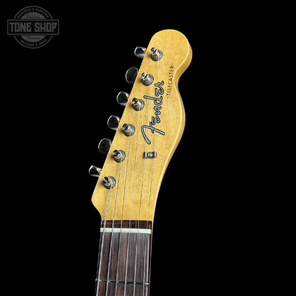 Close-up of a Fender Telecaster guitar headstock on a black background