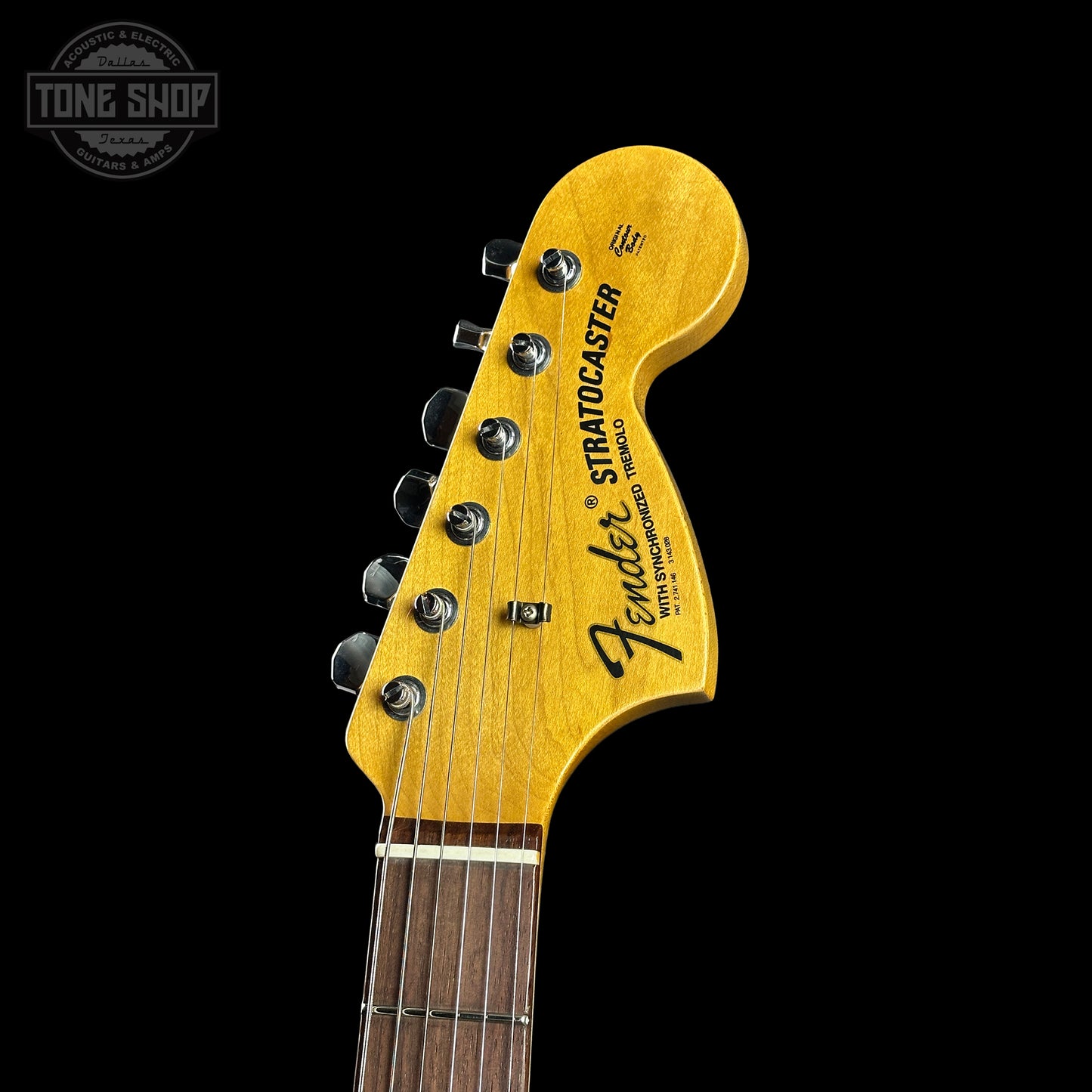 Fender Stratocaster guitar headstock on a black background