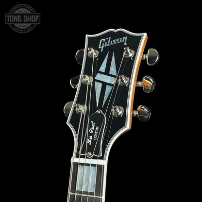 Gibson guitar headstock with brand logo on a black background