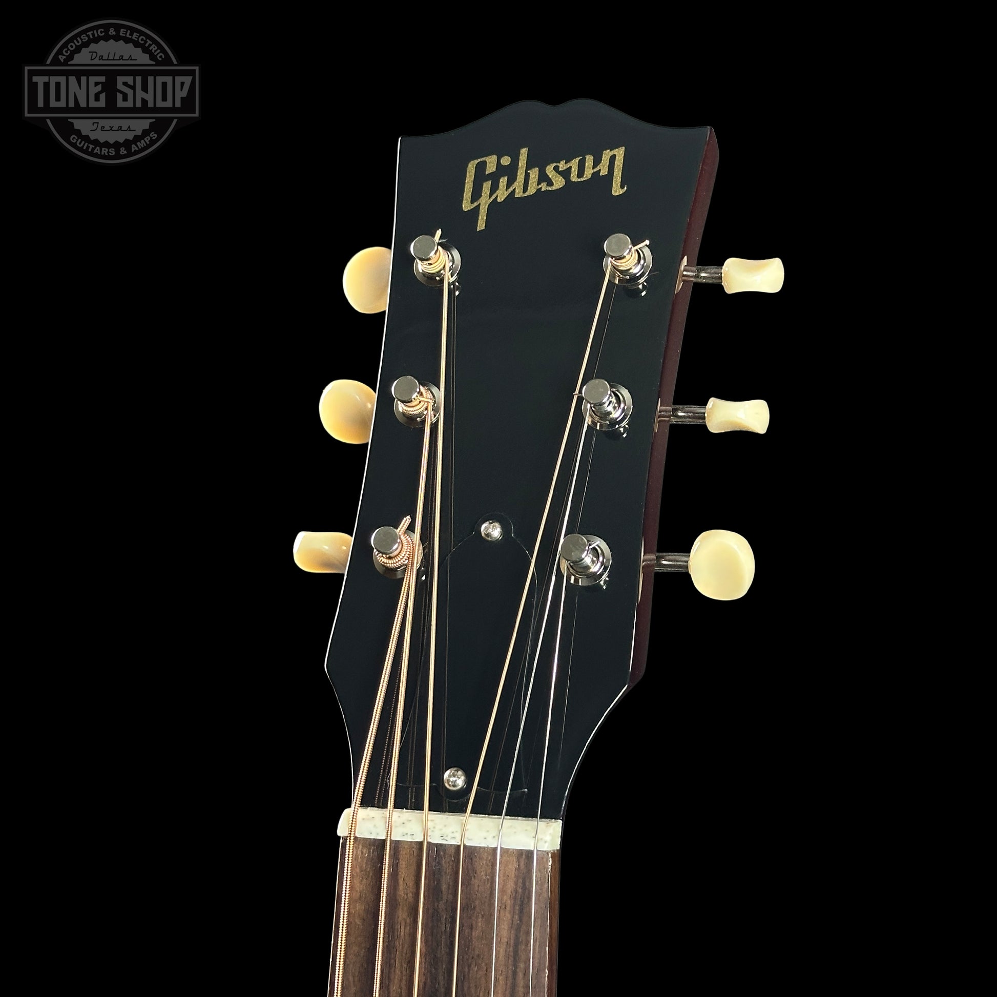 Gibson guitar headstock with brand logo on a black background
