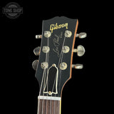 Gibson Les Paul guitar headstock with brand logo on a black background
