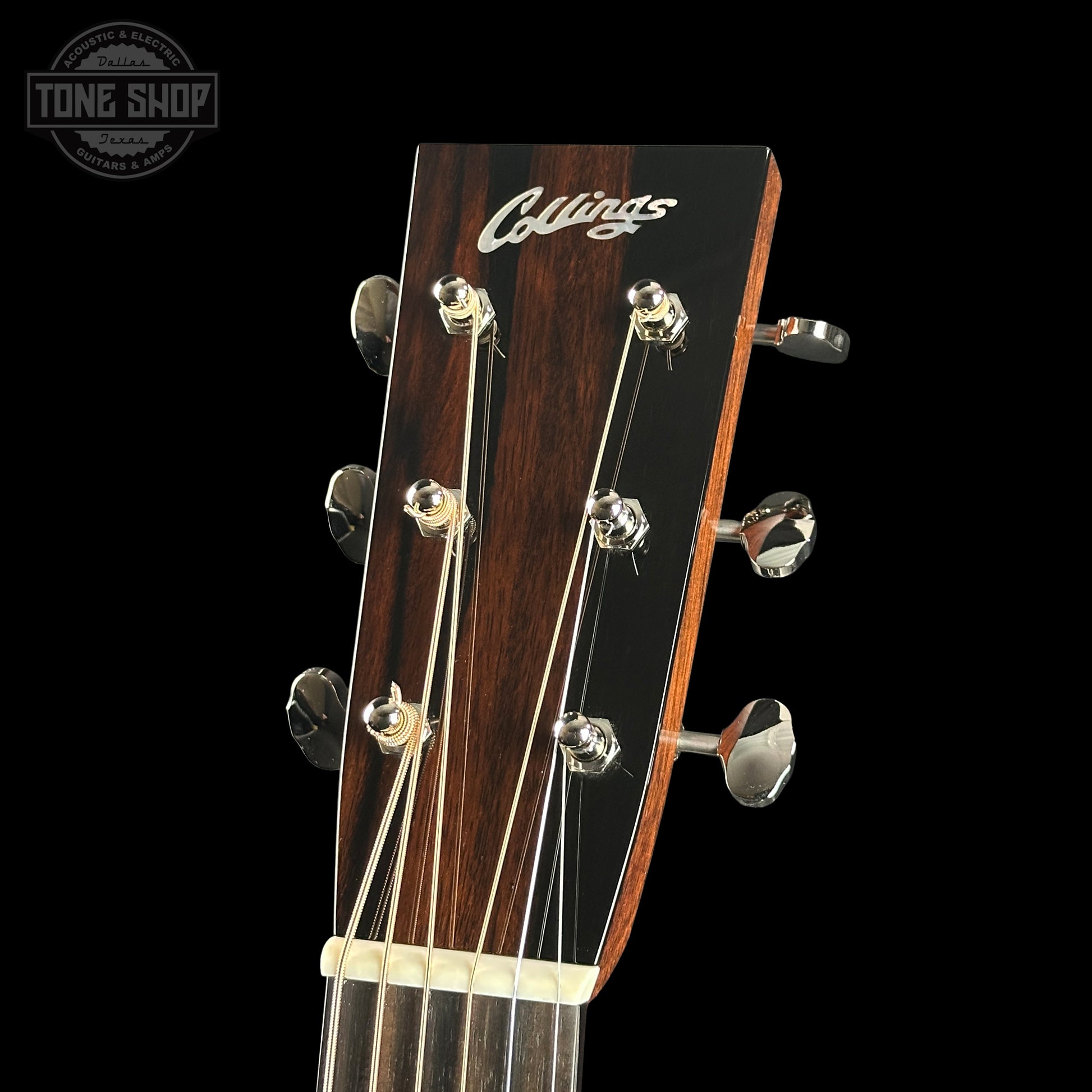 Guitar headstock with 'Collings' logo on a black background
