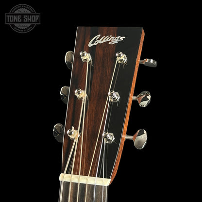 Guitar headstock with 'Collings' logo on a black background