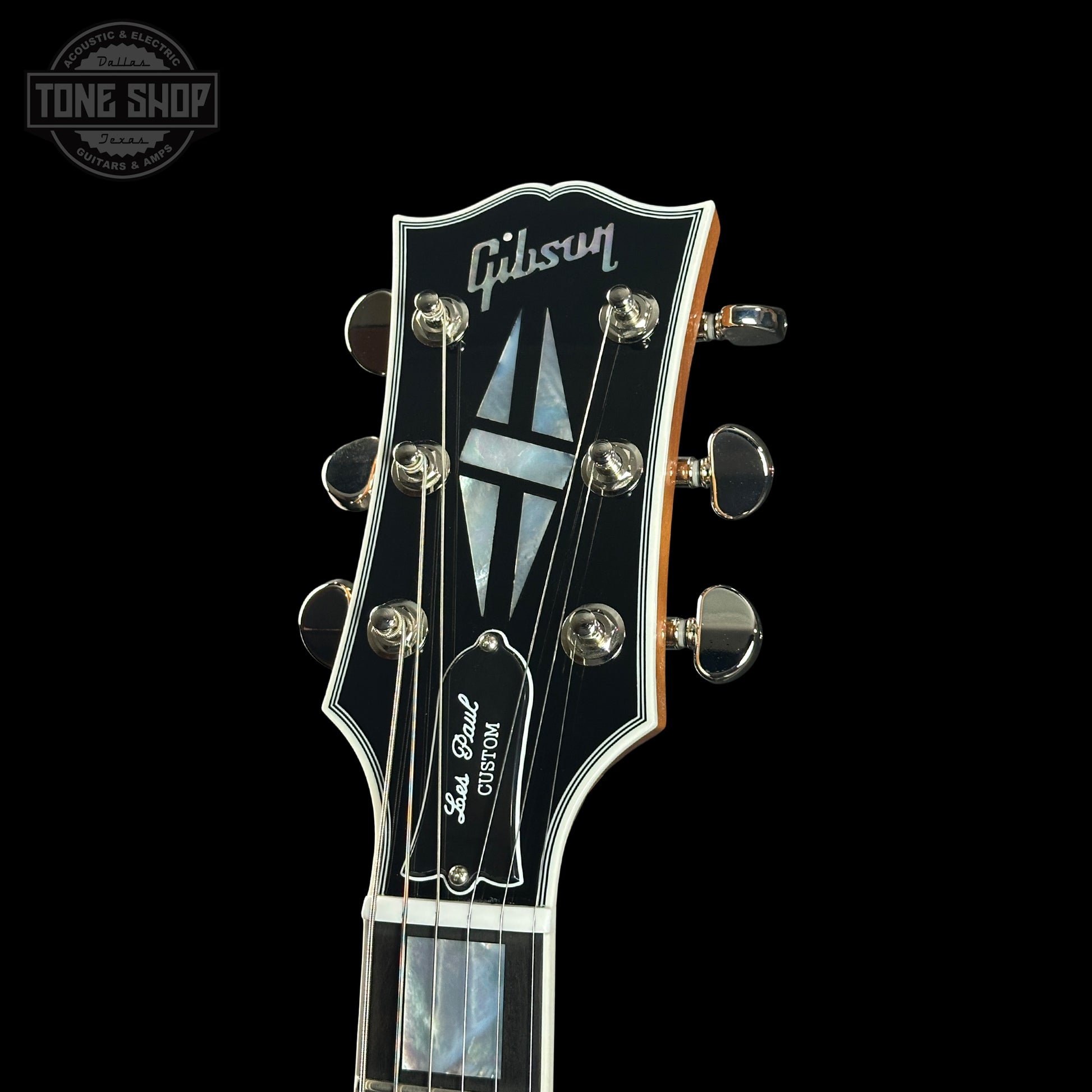 Gibson Les Paul guitar headstock on a black background