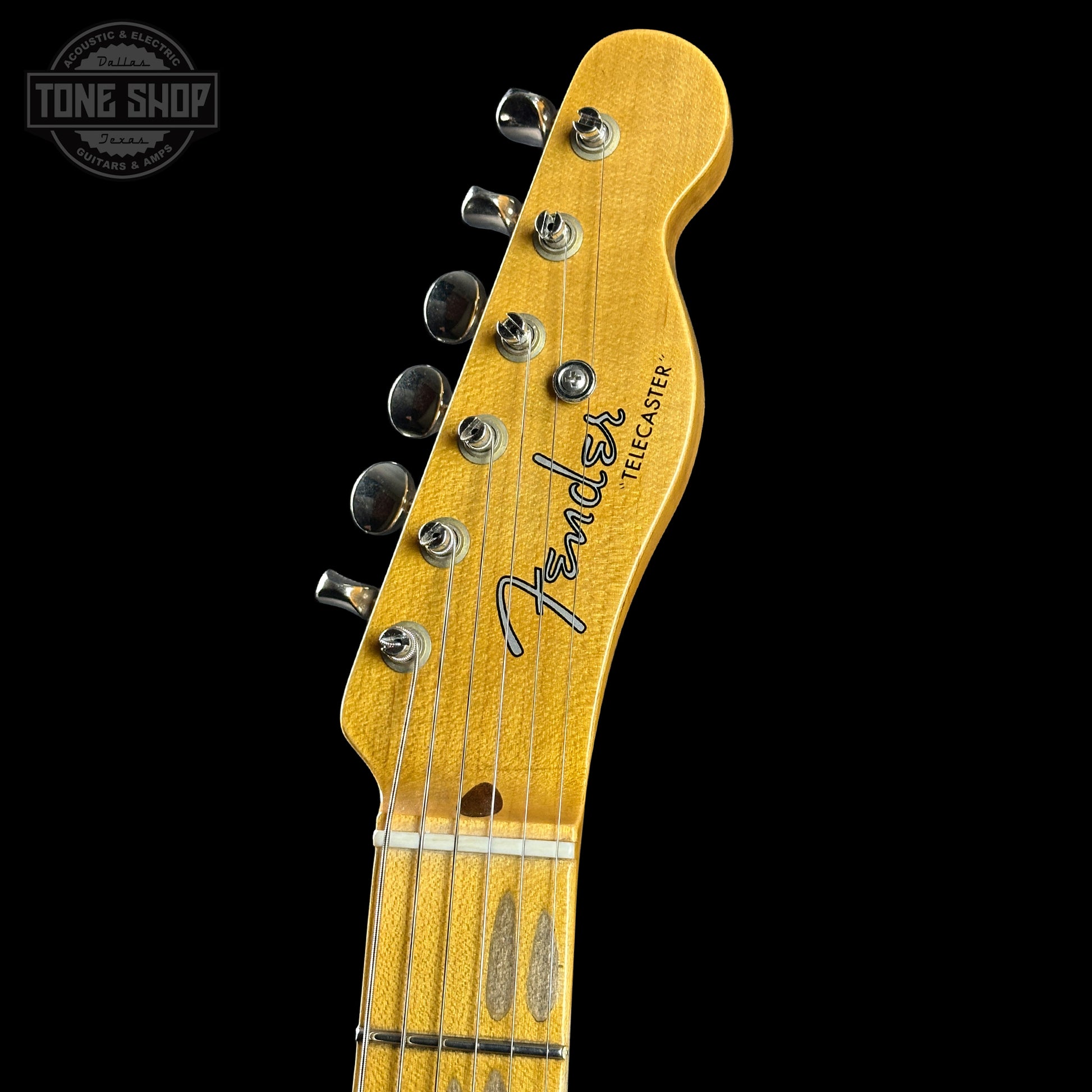 Fender Telecaster guitar headstock on a black background