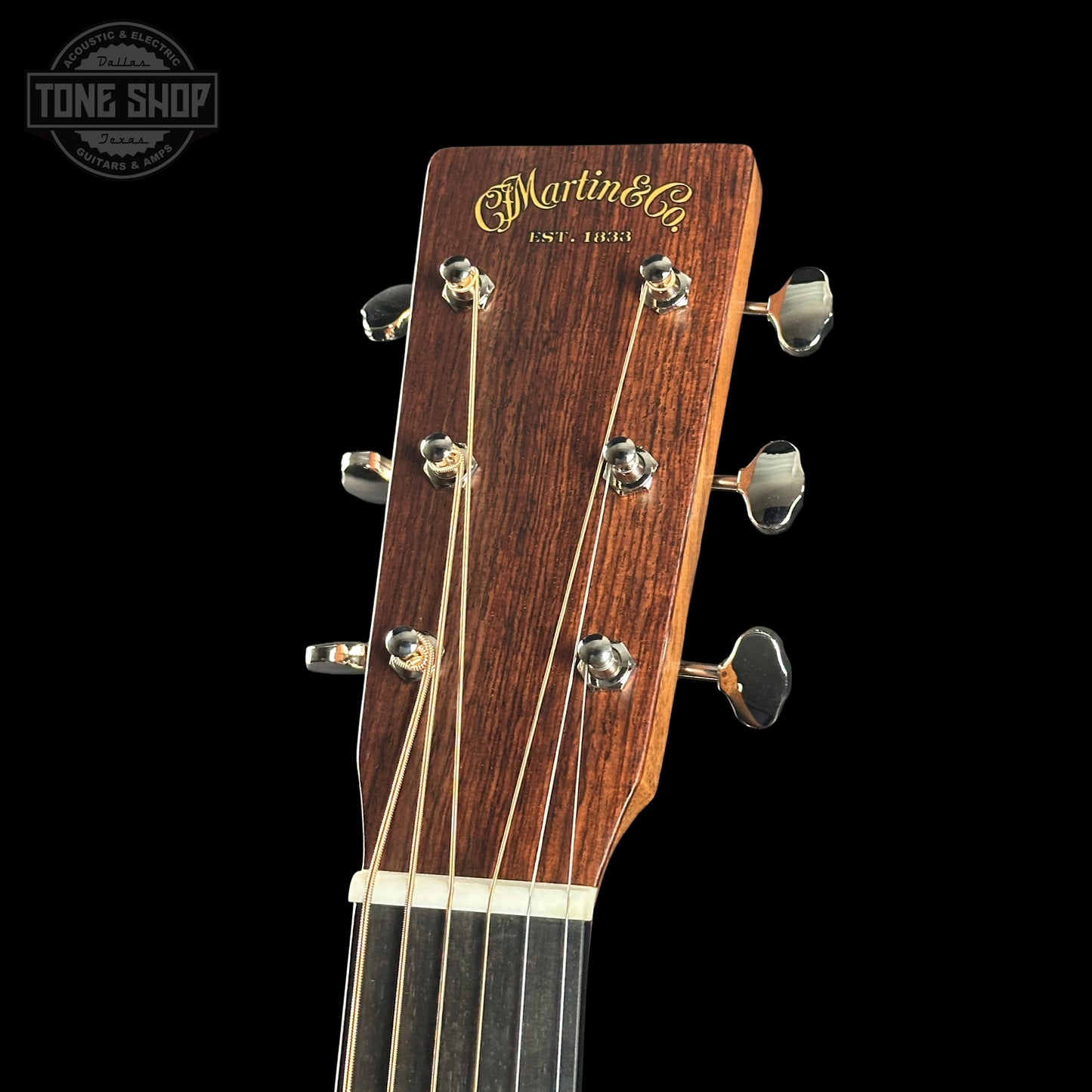 Guitar headstock with Martin & Co logo on a black background