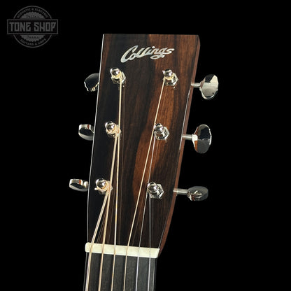 Collings guitar headstock with tuning pegs on a black background