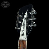 Guitar headstock with 'Rickenbacker' branding on a black background