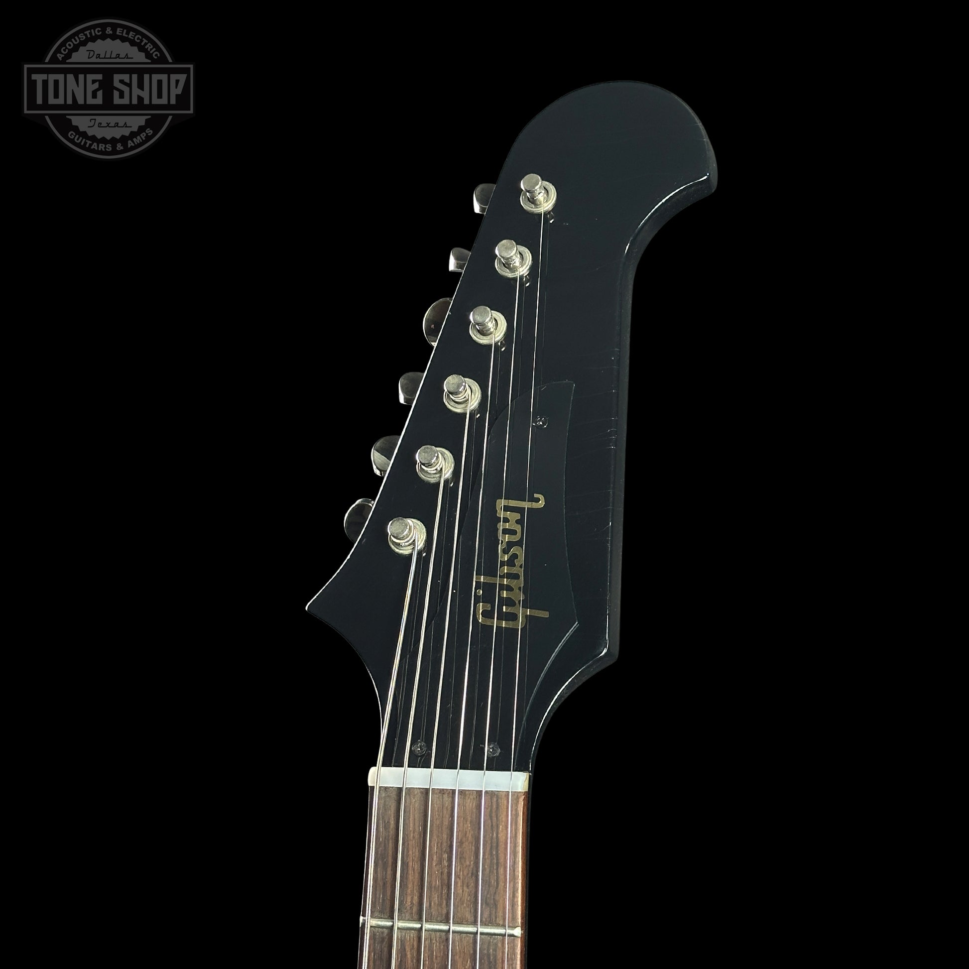 Guitar headstock with Gibson branding on a black background