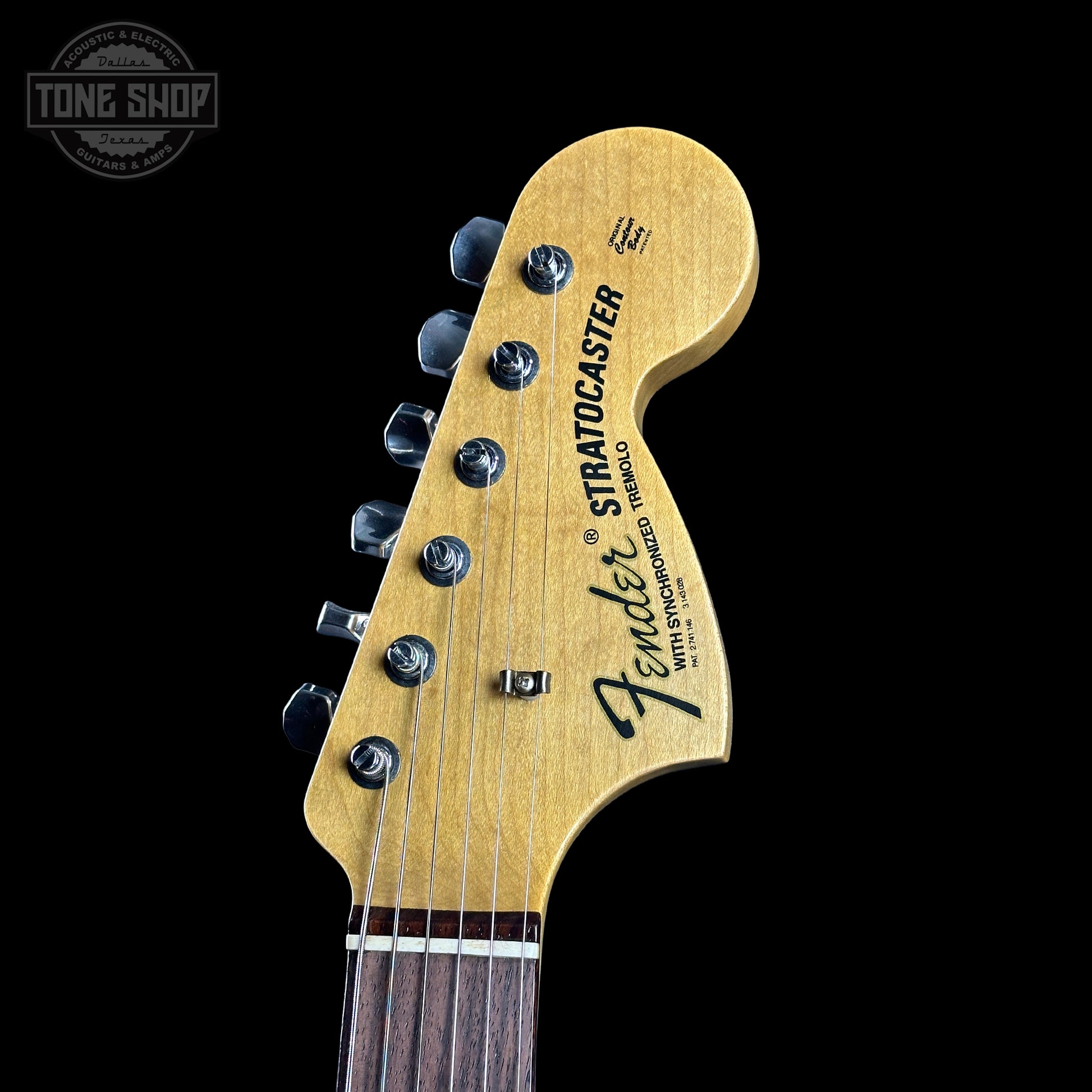 Fender Stratocaster guitar headstock on a black background