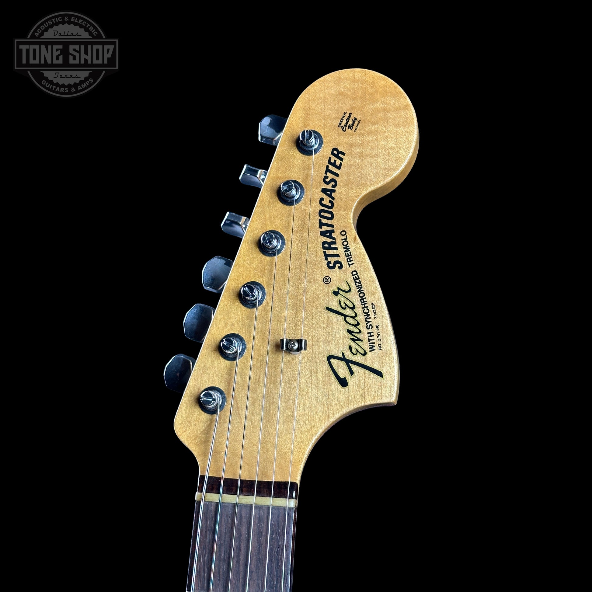 Fender Stratocaster headstock on a black background