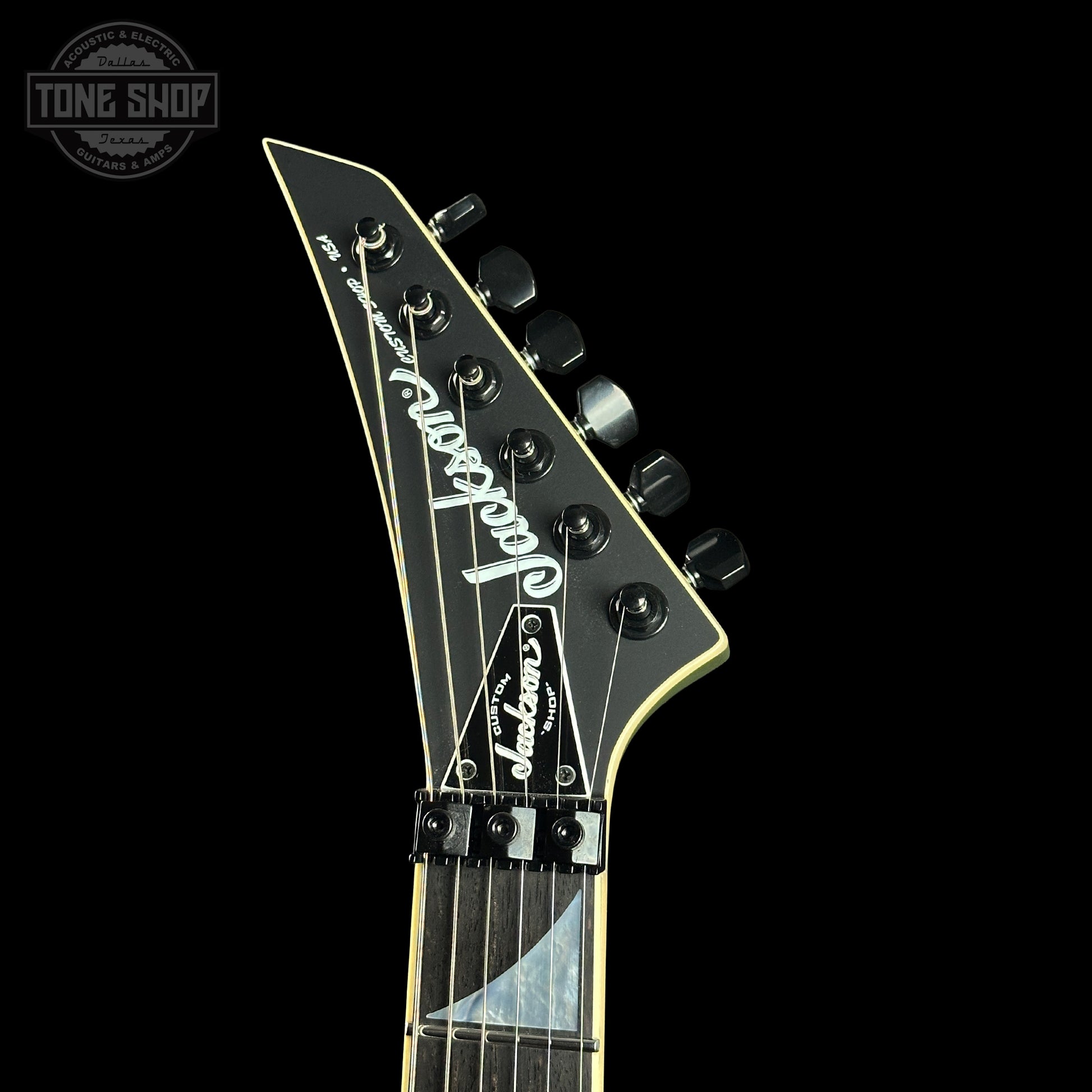 Jackson guitar headstock on a black background with 'Tone Shop' logo.