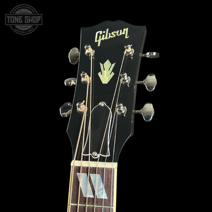Gibson guitar headstock with brand logo on a black background
