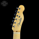 Guitar headstock with Fender logo on a black background