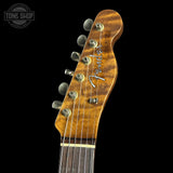 Fender guitar headstock with 'Tone Shop' logo in the corner