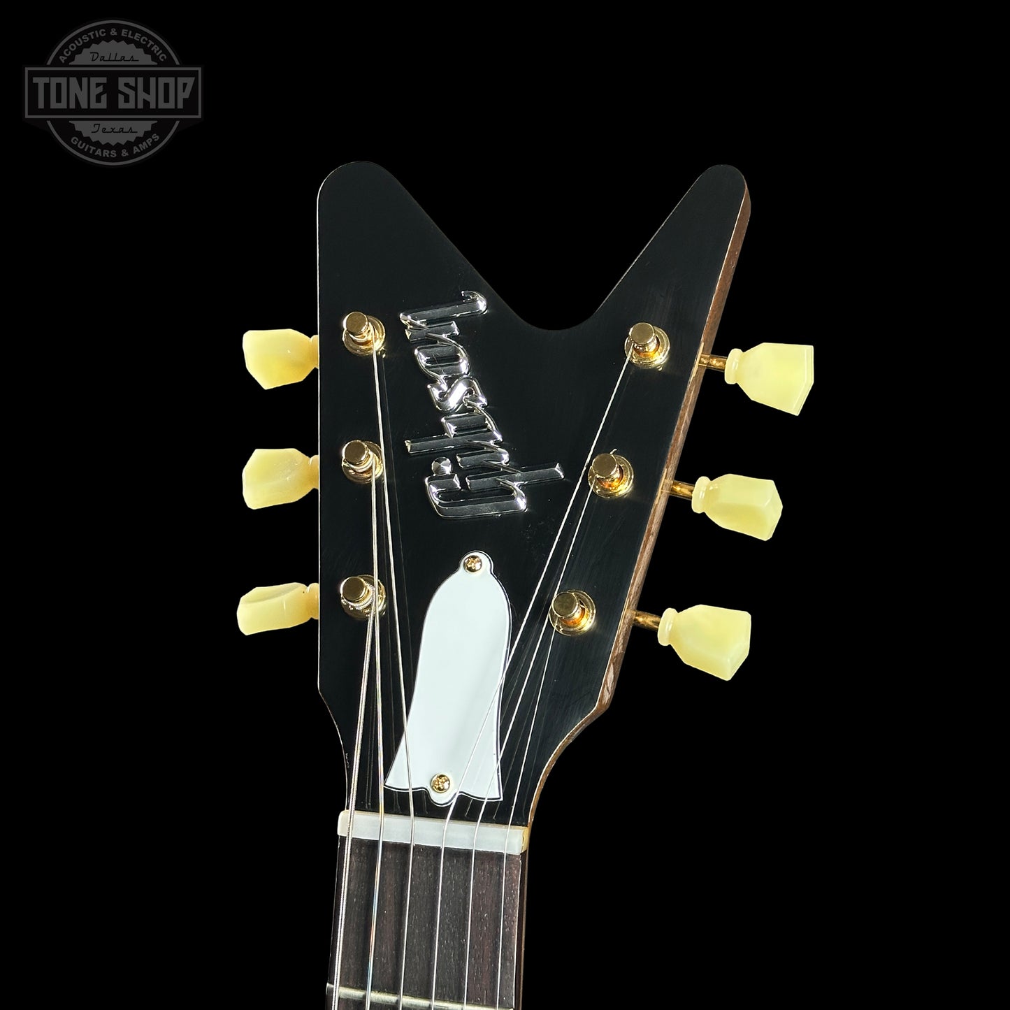 Close-up of a guitar headstock with 'Ibanez' branding on a black background.