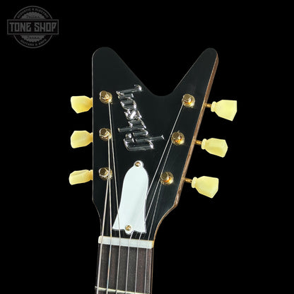 Close-up of a guitar headstock with 'Ibanez' branding on a black background.