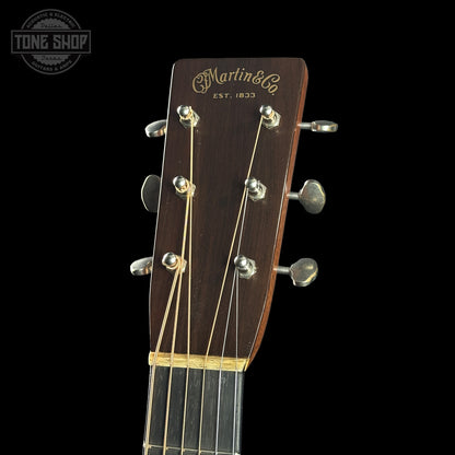 Guitar headstock with Martin & Co. branding on a black background
