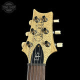 Guitar headstock with brand logo on a black background