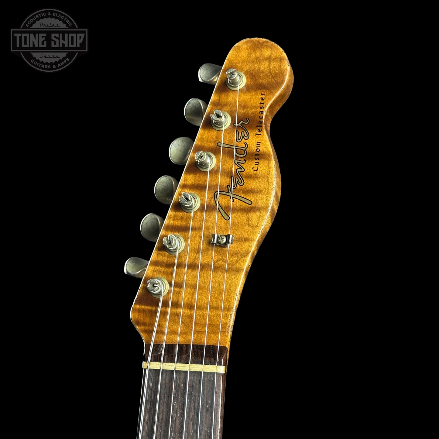 Fender guitar headstock with 'Tone Shop' logo in the corner