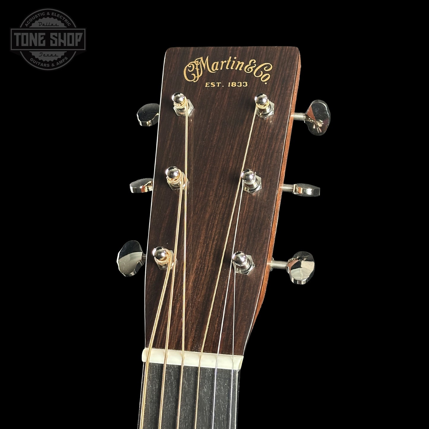 Guitar headstock with Martin & Co logo on a black background