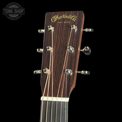 Guitar headstock with 'Martin & Co' branding on a black background