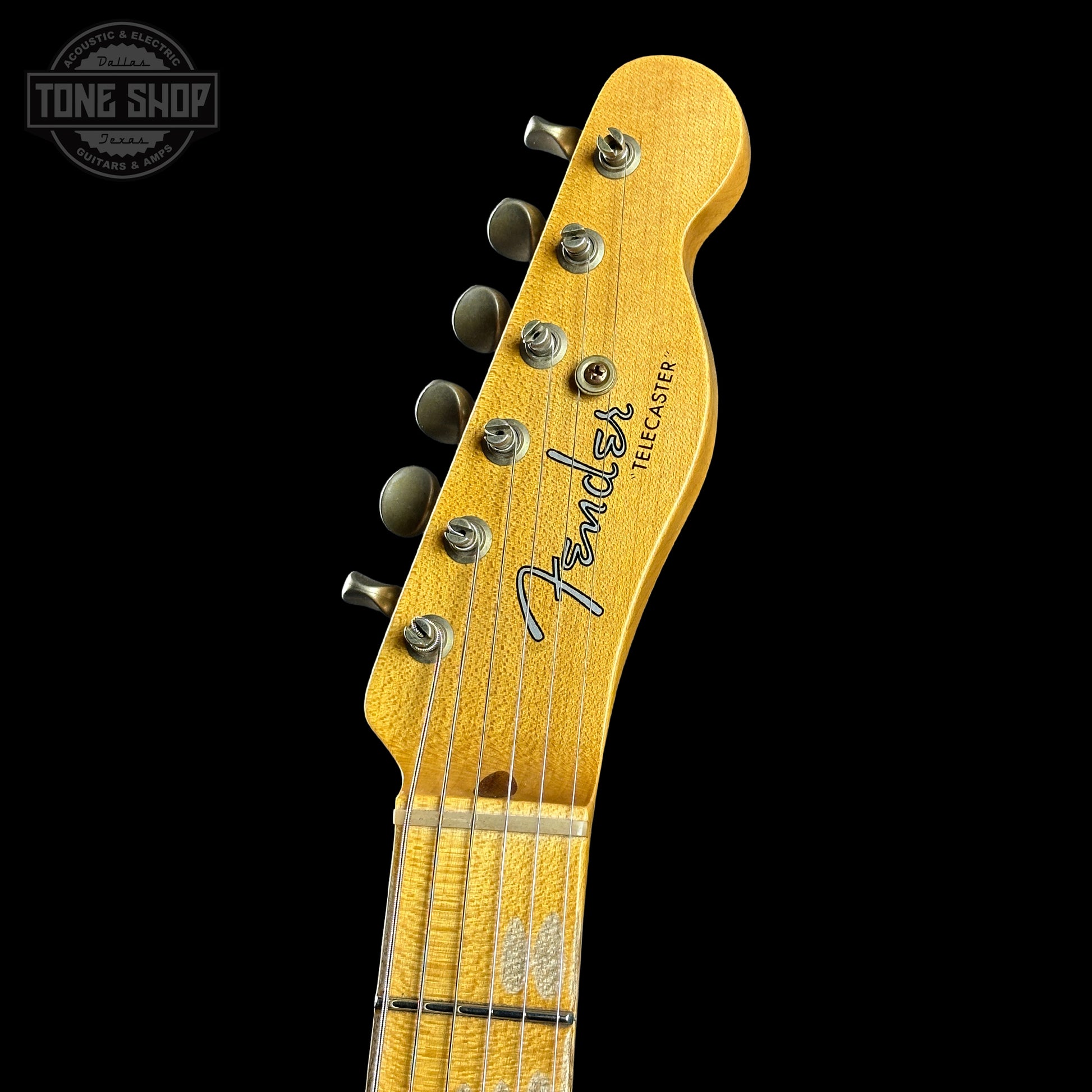 Fender guitar headstock on a black background with 'Tone Shop' logo.