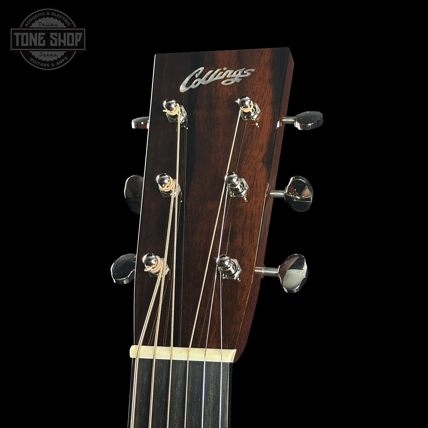 Guitar headstock with 'Collings' logo on a black background