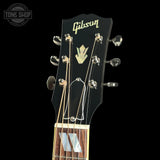 Gibson guitar headstock with brand logo on a black background